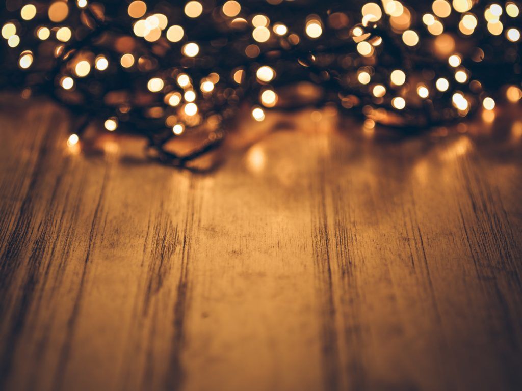 tangled christmas lights on a wood desk